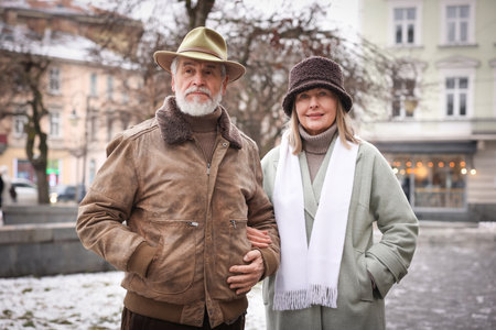 Lovely senior couple walking on city streetの写真素材