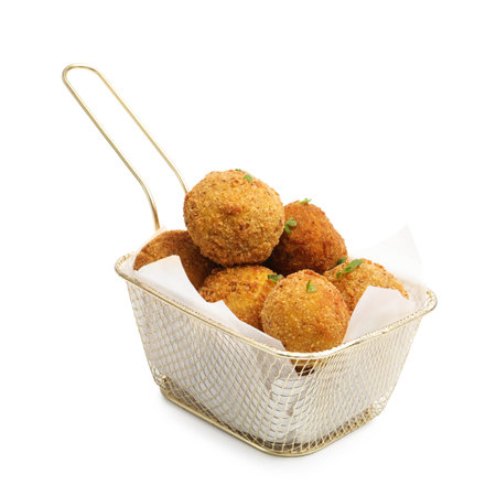 Delicious fried croquette balls with parsley in metal basket isolated on white