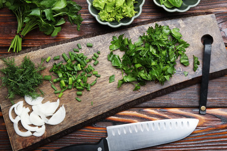 Different fresh herbs, spices and knife on wooden table, flat lay