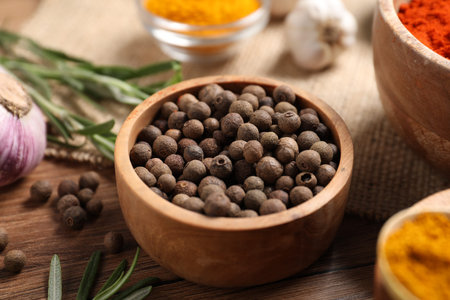 Different aromatic spices on wooden table, closeup