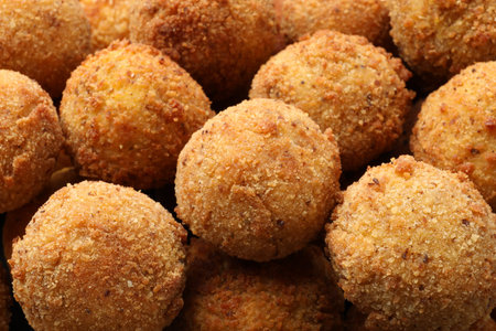 Delicious fried croquette balls as background, closeup