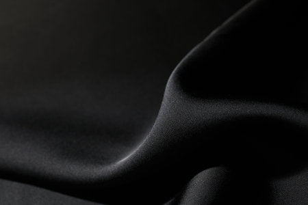 Crumpled black silk fabric as background, closeup