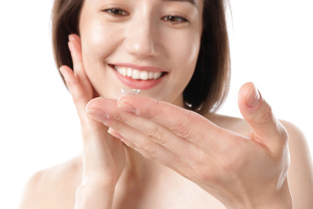 Woman with contact lens on white background, selective focusの写真素材