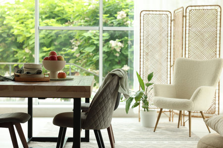 Wooden table, chairs, armchair and decor in dining room. Interior designの写真素材