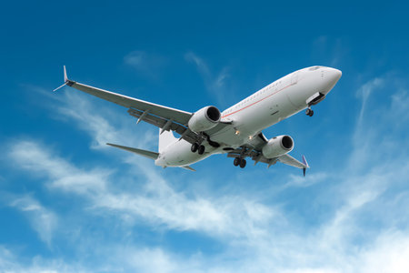 Airplane flying in beautiful blue sky with clouds