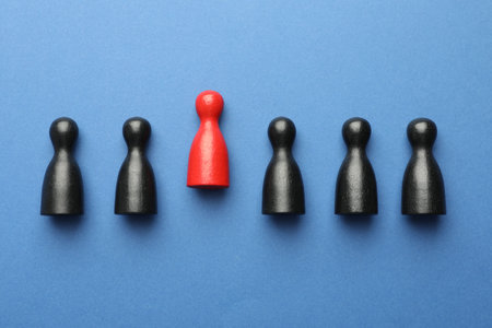 Unemployment. One red figure among black on blue background, flat layの写真素材