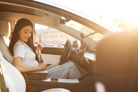 Woman fastening seat belt in modern car, view from outside