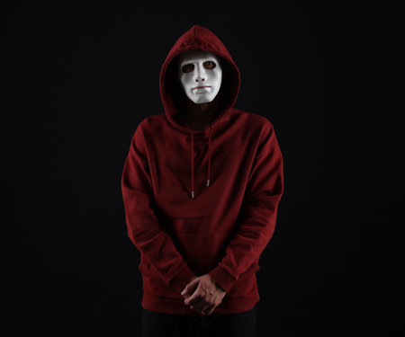 Anonymity. Man wearing mask on dark background