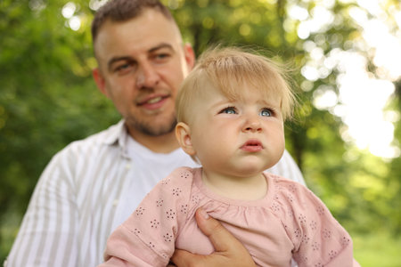 Dad and his newborn baby outdoors, closeup. Happy Father's Day