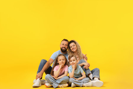 Happy family on yellow background. Space for text