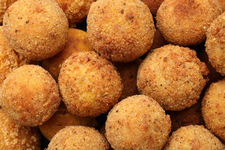 Delicious fried croquette balls as background, top view