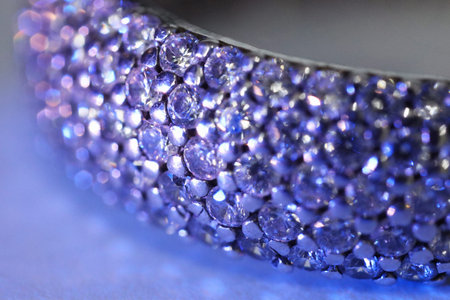 Ring with beautiful shiny diamonds on light background, macro view. Color toned