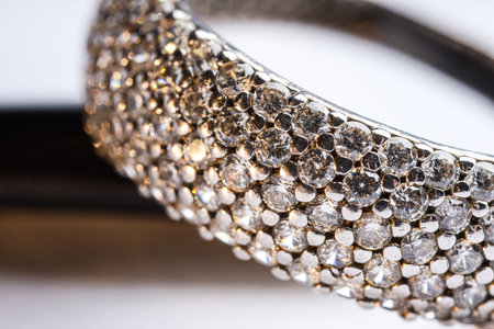 Ring with beautiful shiny diamonds on light background, macro view
