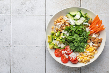 Different healthy vegetarian food on light tiled table, top view. Space for textの写真素材