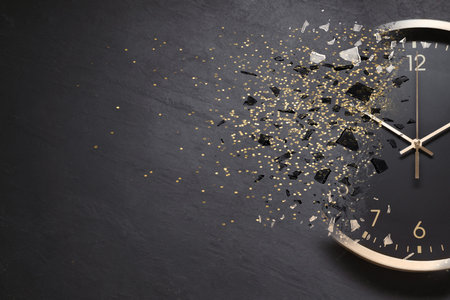 Time running out. Clock dissolving on gray textured background