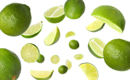 Fresh ripe limes flying on white backgroundの写真素材