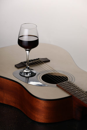 Acoustic guitar and red wine on white background, closeupの写真素材