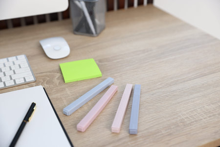 Different stationery on wooden desk indoors, closeup