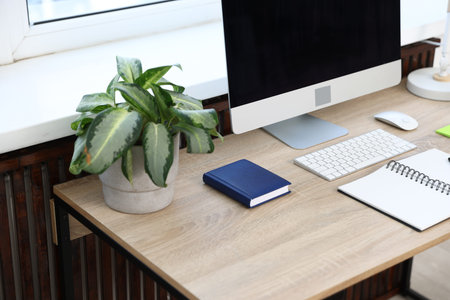 Stylish workplace with modern computer on wooden desk, closeup