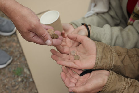 Man giving money to homeless people outdoors, closeupの写真素材