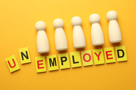 Word Unemployed and human figures on yellow background, flat layの写真素材