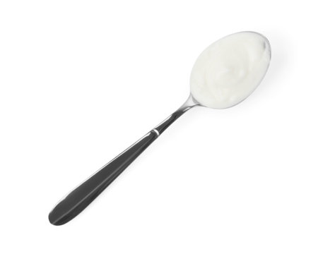 Tasty yoghurt in spoon isolated on white, top viewの写真素材