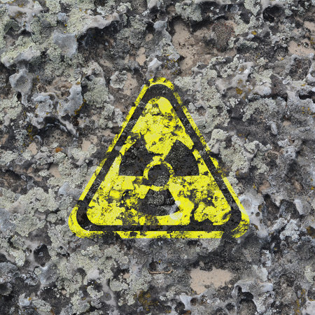 Yellow radioactive sign on textured background. Radiological pollution