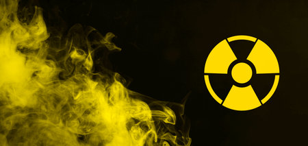 Radioactive sign and yellow toxic smoke against black background. Banner designの写真素材