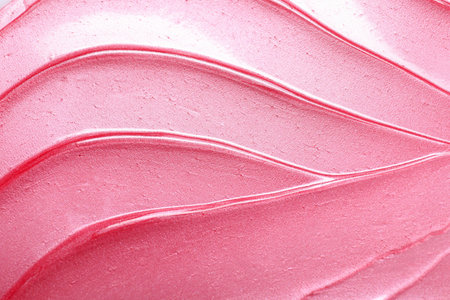 Texture of pink lip gloss as background, top view