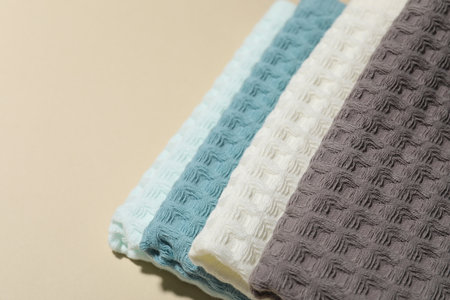 Clean waffle towels on beige background, closeup. Space for textの写真素材
