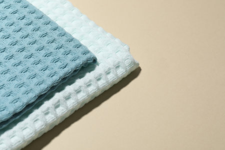 Clean waffle towels on beige background, closeup. Space for textの写真素材