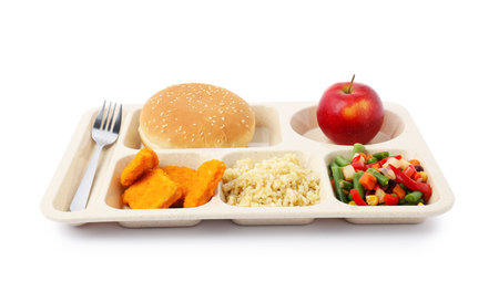 Plastic tray with tasty food and fork isolated on white. School lunchの写真素材