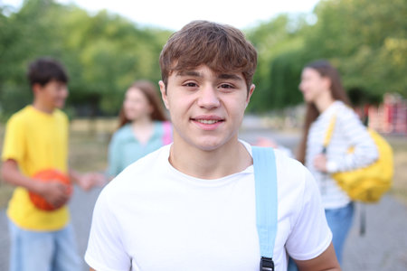 Portrait of teenager with backpack outdoors, selective focus