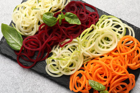 Different vegetable noodles with basil on gray table, top view. Vegetarian dishの写真素材