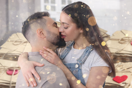 Romantic young couple and love letters, bokeh effect. Woman and man kissing at homeの写真素材