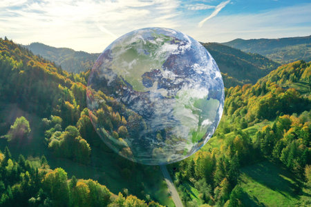 Environment concept. Globe in mountains, double exposure