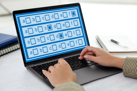 Woman passing online test on laptop at table, closeup