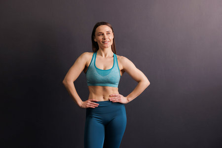 Portrait of professional trainer on black background