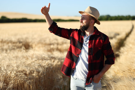 Farmer in field with ripe wheat outdoors