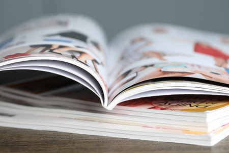 Stack of different magazines on wooden table, closeupの写真素材