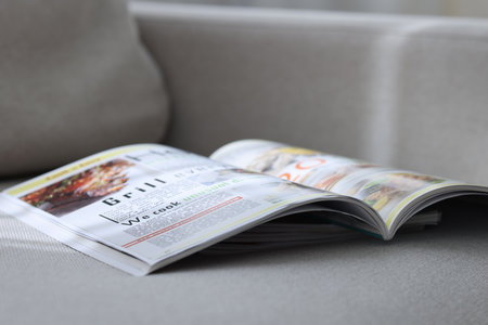 Lifestyle magazines on sofa indoors, closeup viewの写真素材