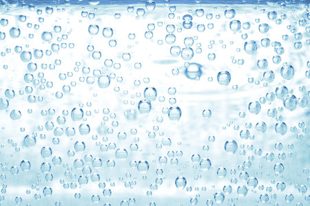 Soda water with bubbles of gas in glass, closeup