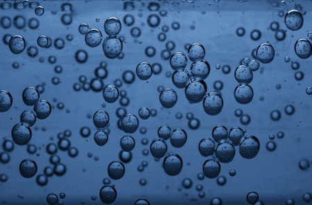 Soda water with bubbles of gas in glass, closeup
