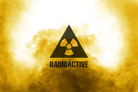 Radioactive sign and yellow toxic smoke against white backgroundの写真素材