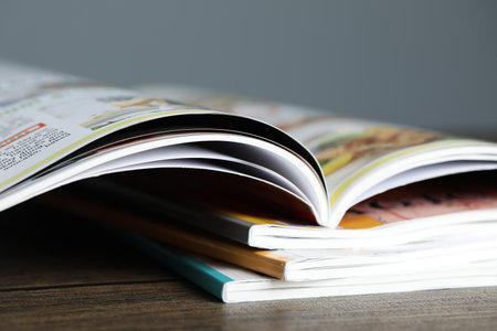 Stack of different magazines on wooden table, closeupの写真素材