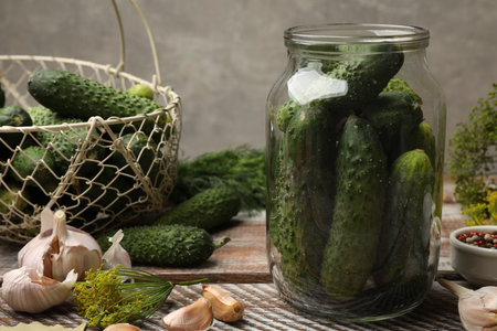 Making pickles. Fresh cucumbers and other ingredients on wooden table, closeupの写真素材