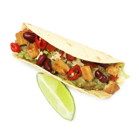Tasty vegetarian taco with beans, tofu, vegetables, guacamole and lime isolated on white, top viewの写真素材