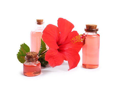 Beautiful red hibiscus flower and cosmetic products isolated on whiteの写真素材