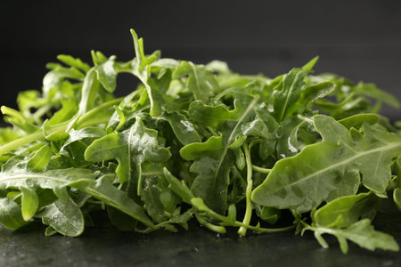 Fresh ripe green arugula leaves on black table, closeupの写真素材