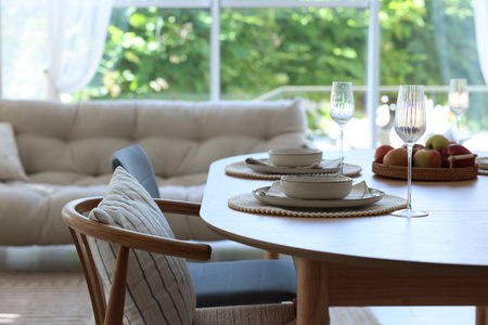 Beautiful table setting, chairs and decor in dining room. Interior designの写真素材